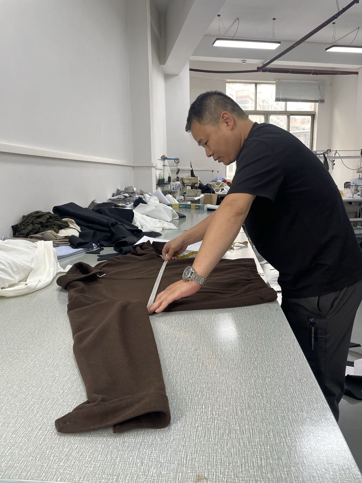 Quality-control team checking garment measurements