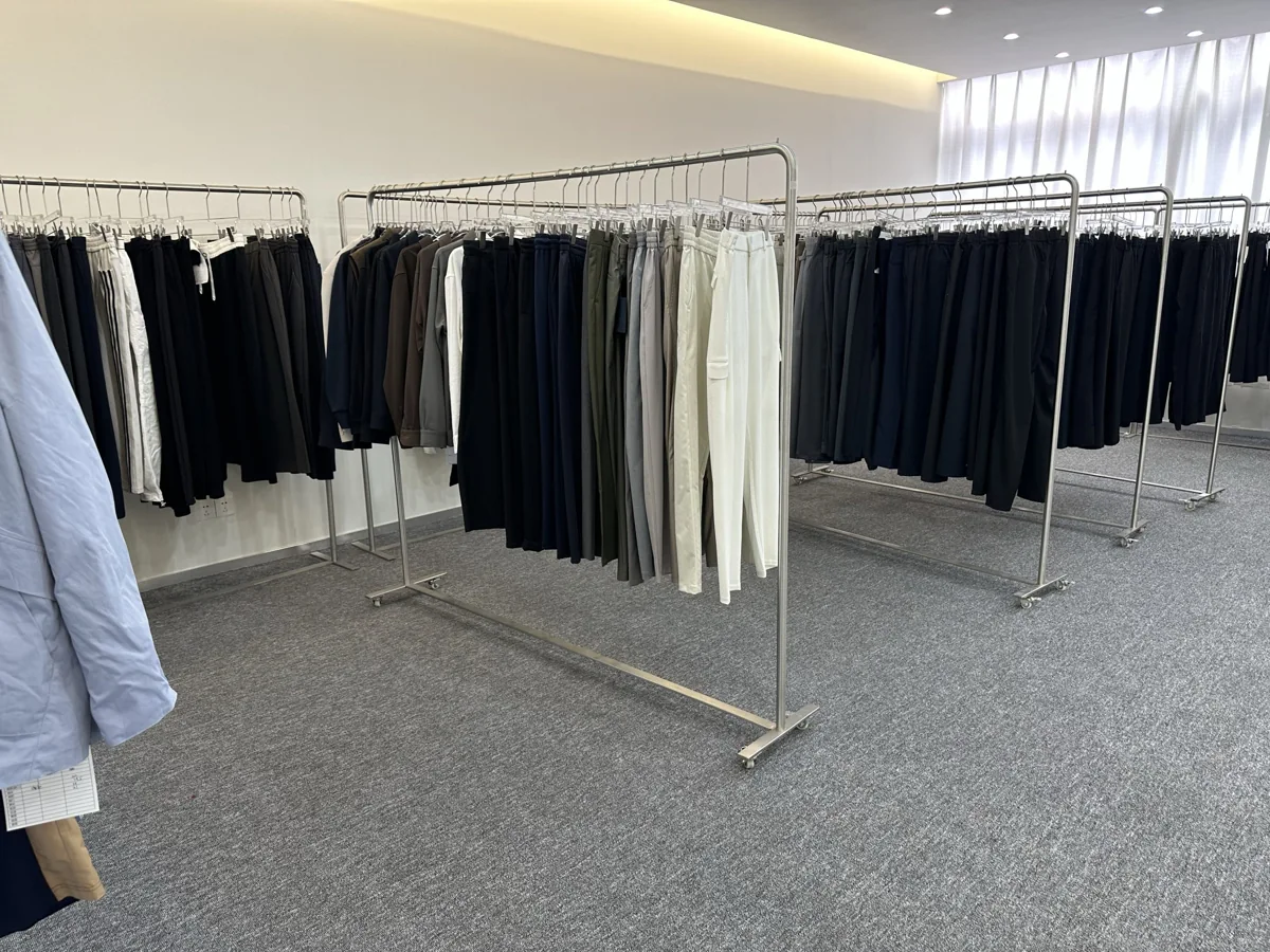 Clothing samples arranged on garment rails at HaoboMFG in Foshan